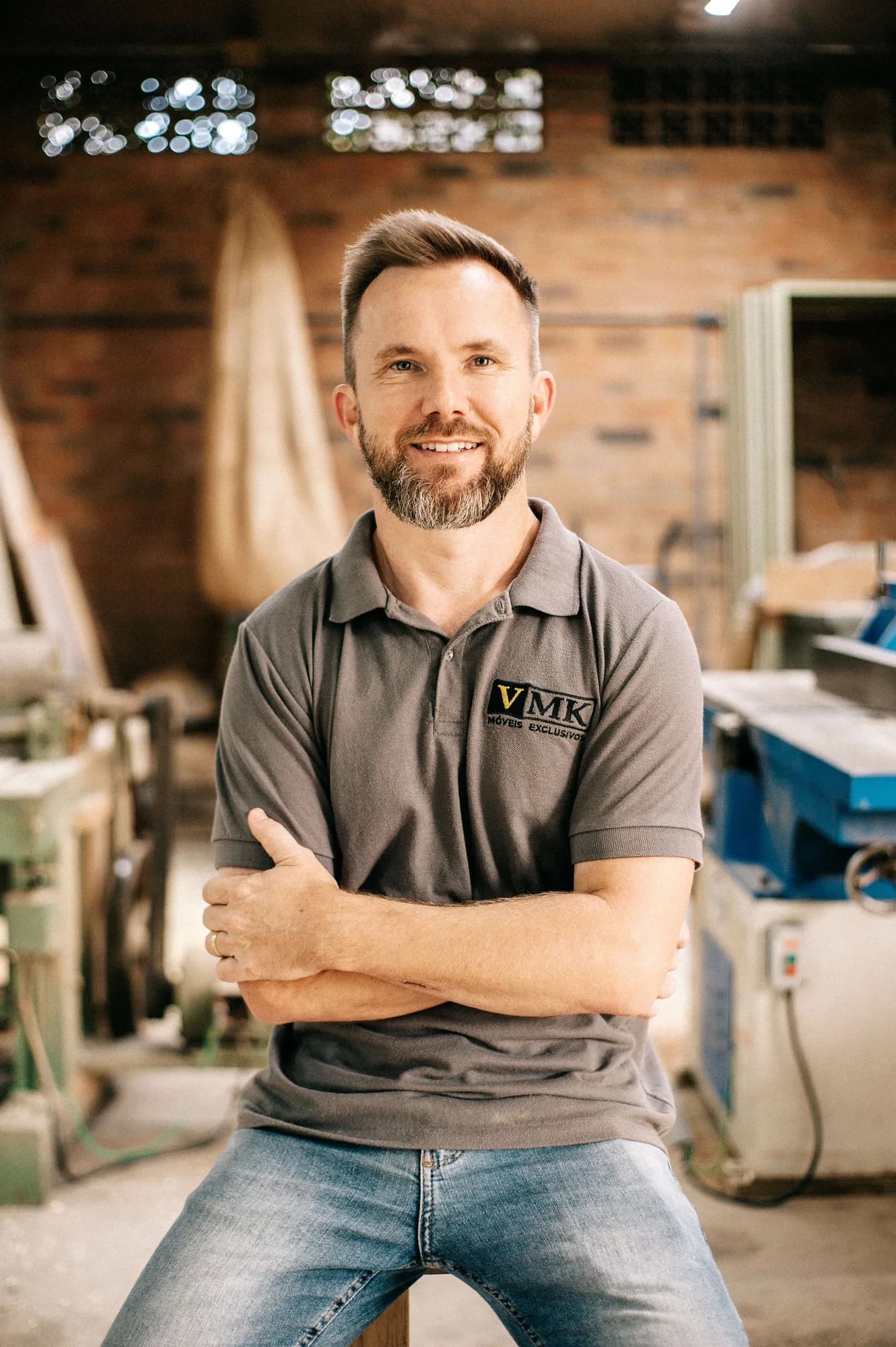 Experienced woodworker smiling inside his workshop