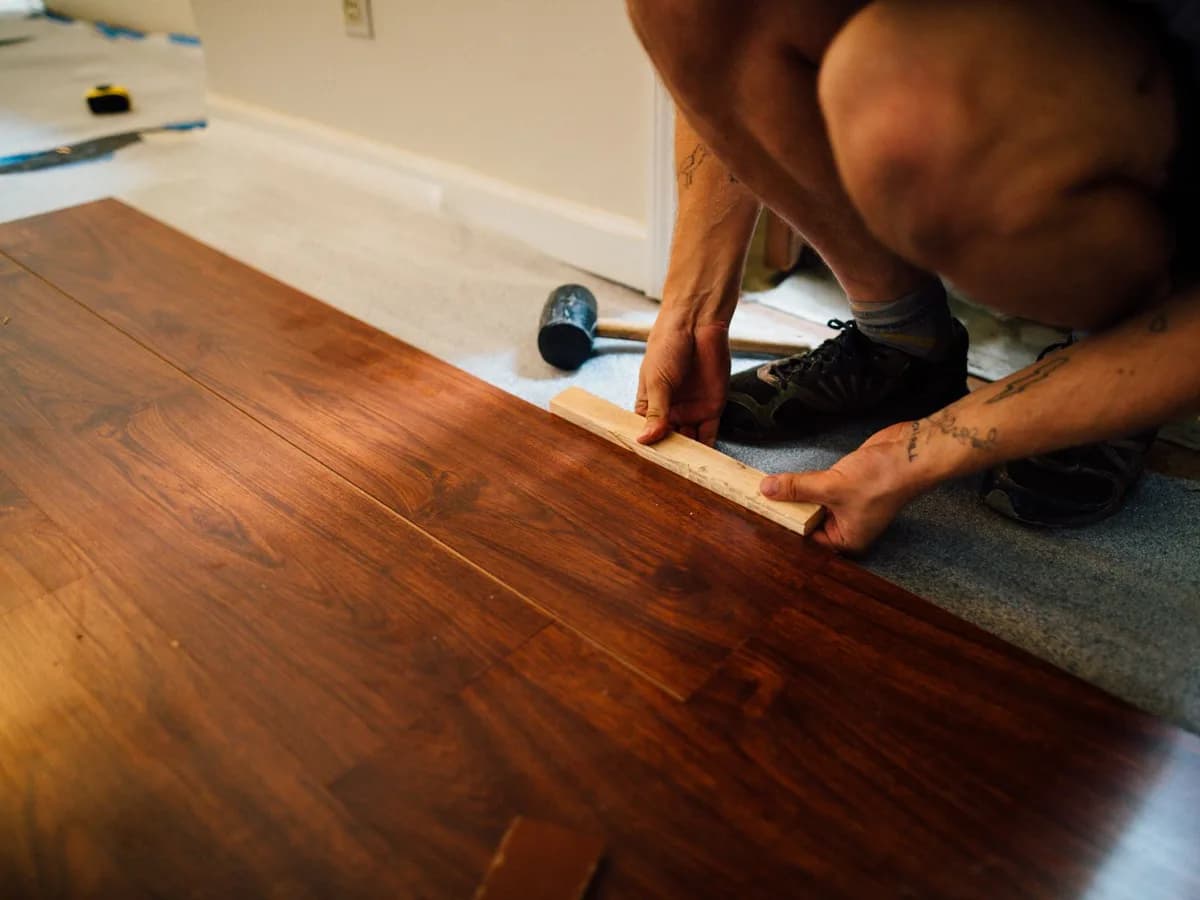 Flooring contractor installing hardwood flooring