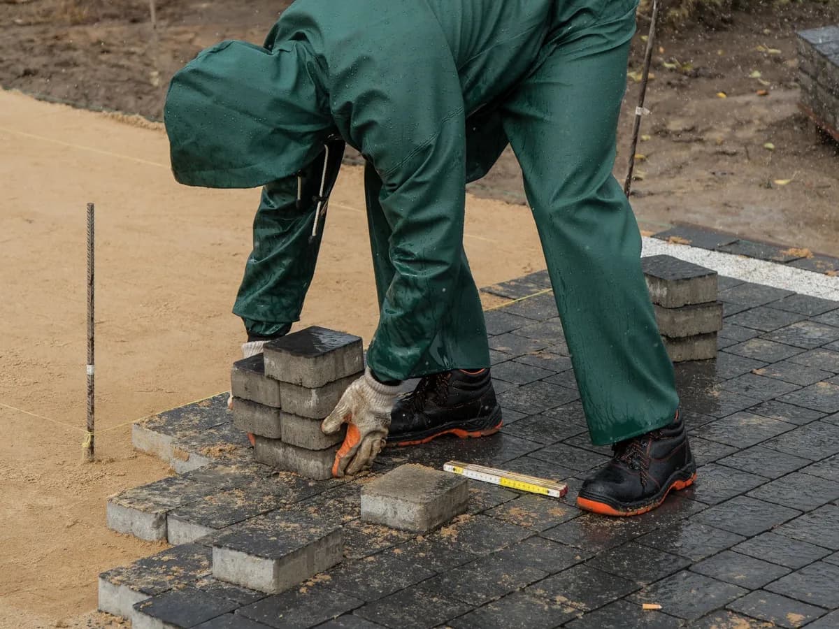 Hardscaping contractor installing patio pavers