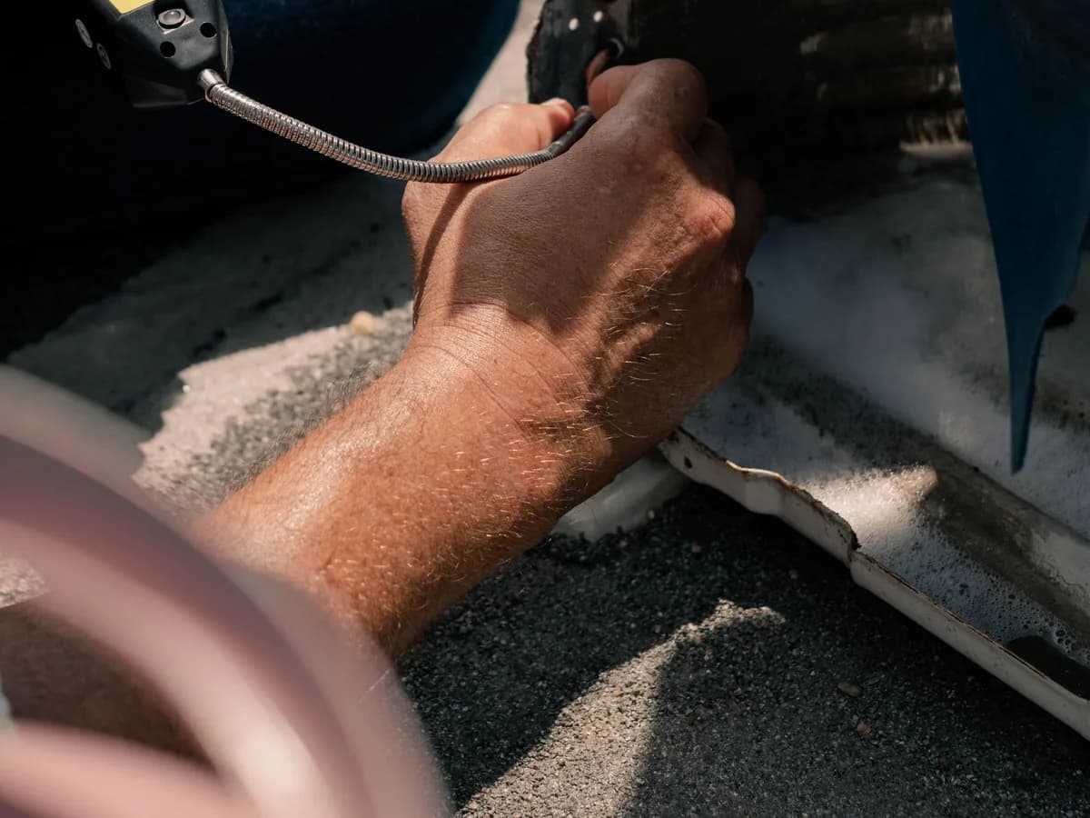 HVAC technician repairing residential air-conditioning equipment