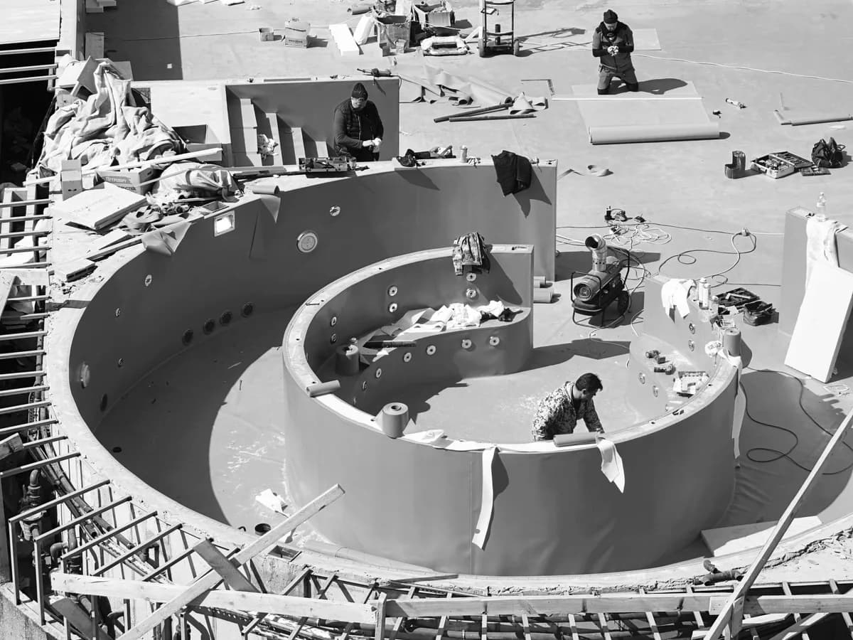 Construction crew building a residential swimming pool